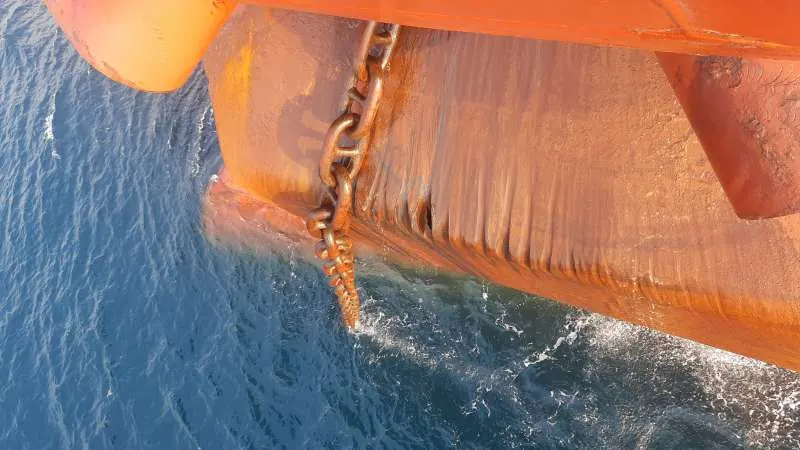 Vessel bow and anchor chain seen from the water